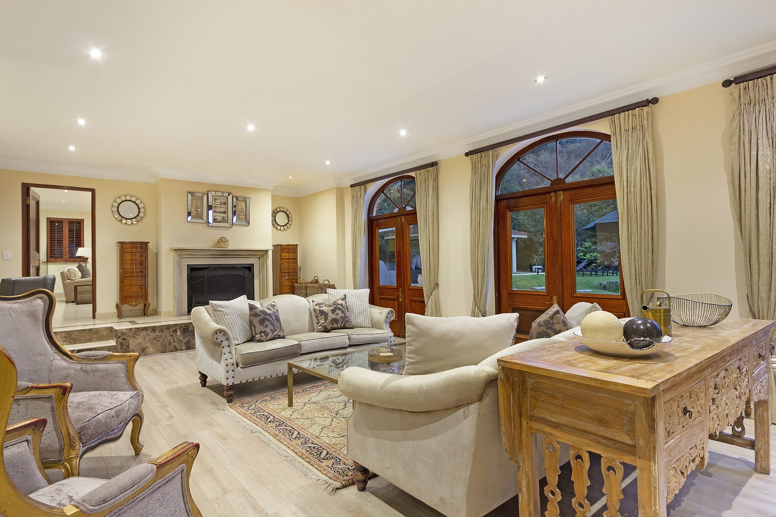 Light-filled living room with sofas and doors to the terrace